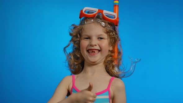 Curly Girl with a Swimming Mask and Snorkel is Showing Big Thumb