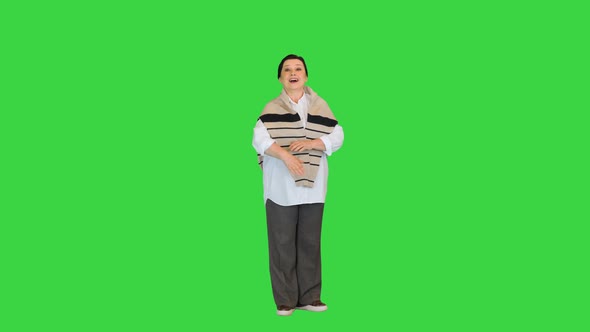 Senior or Middle Age Calling or Welcoming You on a Green Screen Chroma Key
