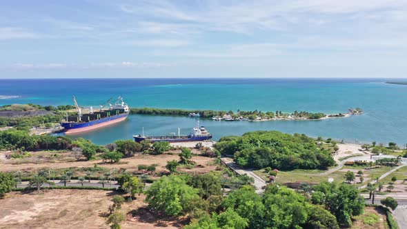 Aerial flight showing Marina of Barahona during beautiful ocean view in summer - Docking industrial