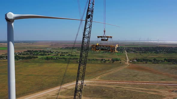 Footage of a Massive Crane Near a Wind Turbine in the Field, Assembly, 