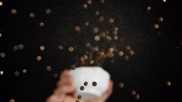 Pepper Falling on Glass on Black Background Using Seasoning and Flavors Unscrewing Spices Dispenser