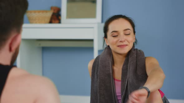 Young Woman Looks at Fitness Tracker