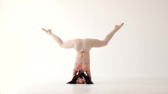 Woman in Beige Costume Dancing Contemp on White Background