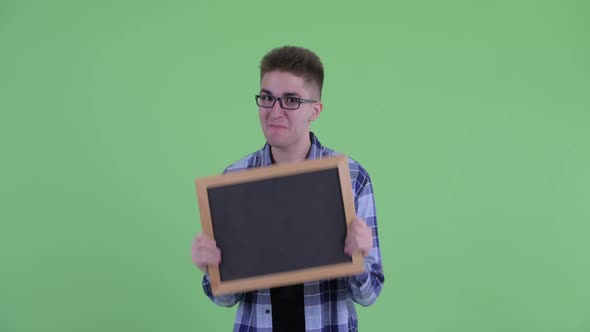 Happy Young Hipster Man Holding Blackboard and Looking Surprised