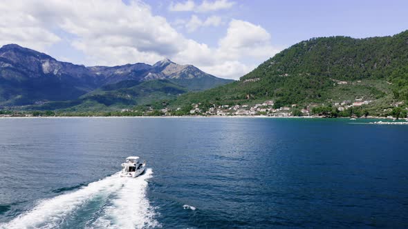 Luxury yacht with family sailing in the sea, drone view, summertime holidays.