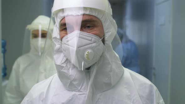 Male Doctor in Protective Uniform Going through Hospital