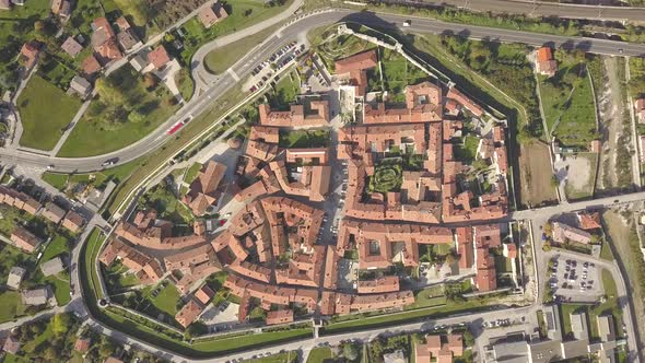 Top down aerial view of a small historic town Venzone in Northern Italy with red tiled roofs