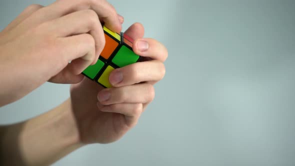 Solving Rubik's cube with hands in studio shot with white background 4k
