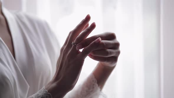 Bride in Night Gown Veil with Engagement Ring Near Window