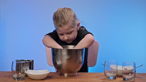 Girl Kneading Dough in Metallic Bowl, Finally Child Licks Fingers with Raw Dough