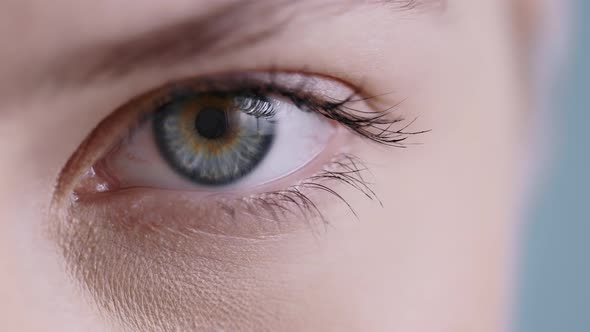 Close Up View of Young Woman Face Half Opening Eye and Looking to Camera 