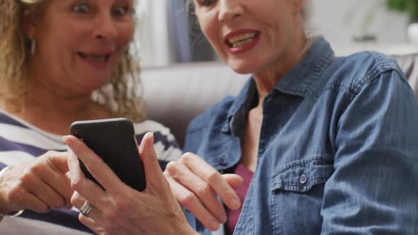 Animation of happy diverse female senior friends using smartphone