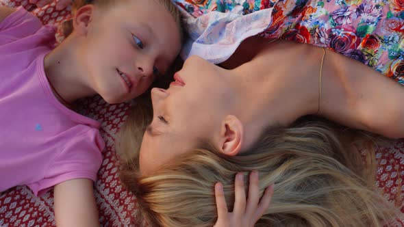 Woman and Girl Nuzzling in Garden