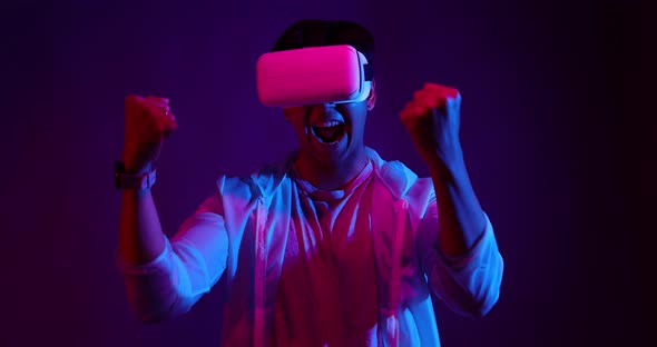 Young Asian man playing metaverse virtual reality digital technology game.