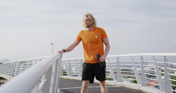 Sporty Caucasian man training on a bridge