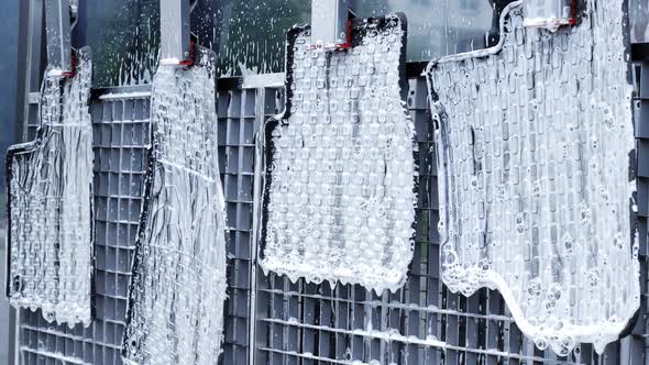 Washing rubber car carpets in a with a hose that supplies water under pressure.