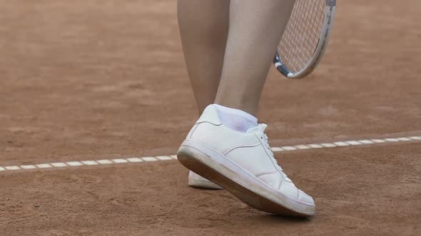 Young Woman With Sexy Legs Playing Tennis, Serving Ball in Short Skirt, Close Up