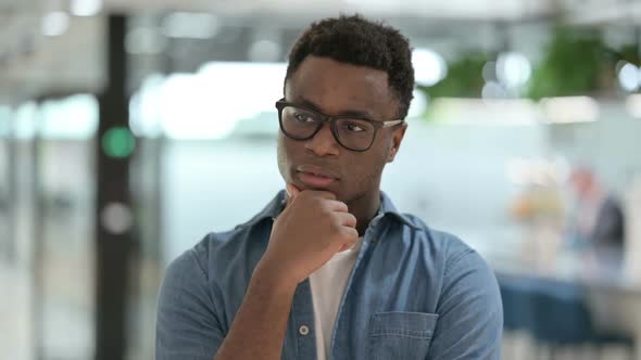 Portrait of Pensive Young African Man Thinking