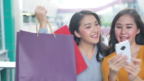 Asian woman wearing face mask. Happy woman with shopping bags