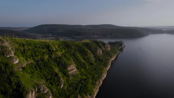 View From Above. Beautiful Shore of Lake or Sea, Rock with Green Trees.