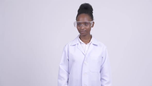 Young Happy African Woman Doctor with Protective Glasses Thinking