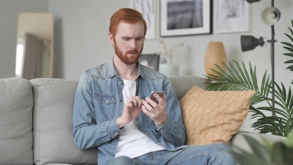 Man Using Smartphone for Online Browsing