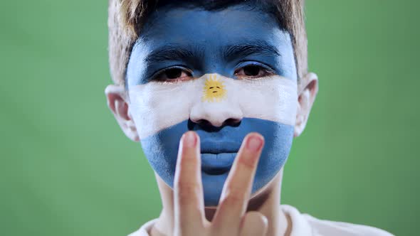 Argentinian fan celebrating victory on green background