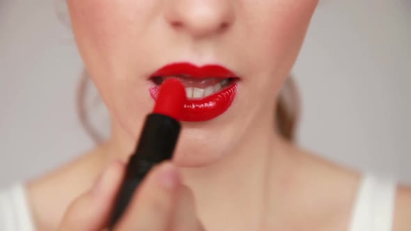 Woman with Red Lips Applying Make Up