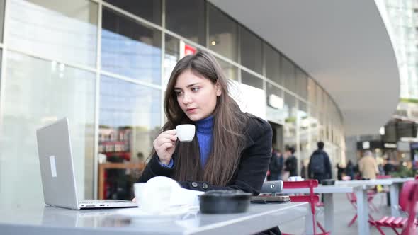 Young business woman drinking coffee using computer remote working