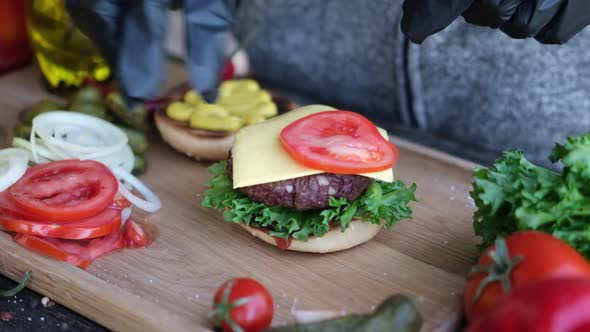 Making Burger  Putting Slices of Tomato on a Cheddar Cheese