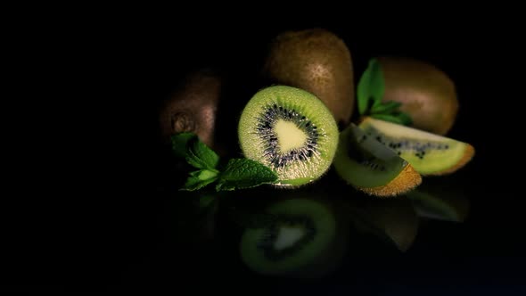 Kiwi Fruits Lie on a Table on a Black Background