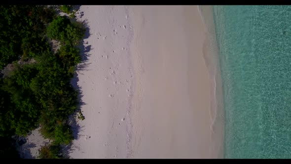 Aerial above travel of idyllic tourist beach trip by transparent ocean and white sand background of 