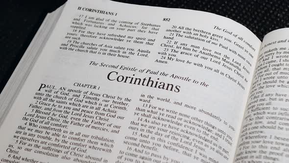 Close Up Shot of  Bible Page Turning to the book of Second Corinthians