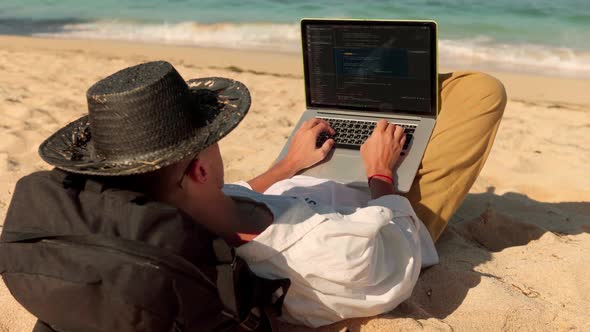 Young Freelancer Lays on Beach and Works Remotely Office Everywhere You Want