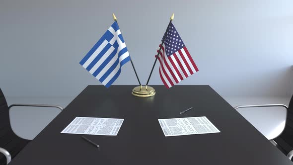 Flags of Greece and the USA on the Table