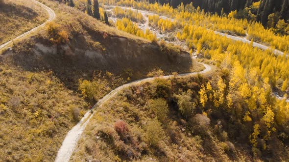 Man Ride Bicycle on the Mountain Road Shot By Drone