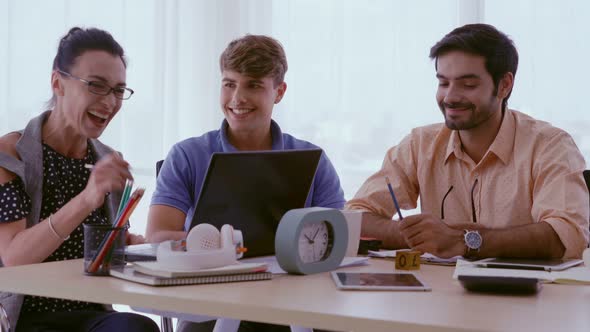 Group Meeting of Creative Business People Designer and Artist at Office Desk