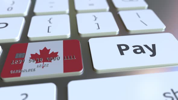 Bank Card with Flag of Canada As a Key on Keyboard alt