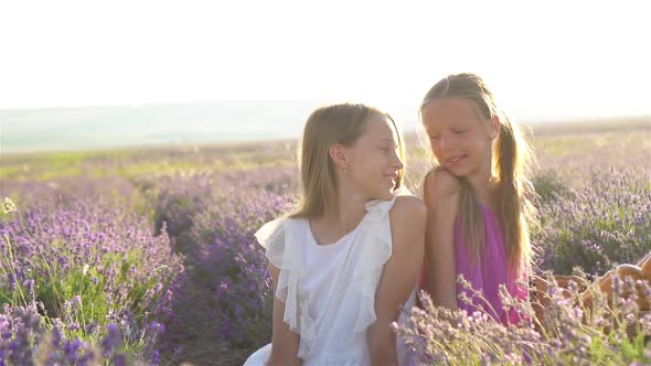 Girls in Lavender Flowers Field at Sunset in White Dress