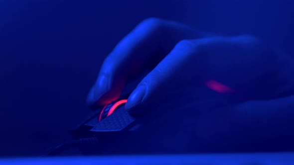 Close Up of Hand Over Wireless Game Mouse on Dark Background The...