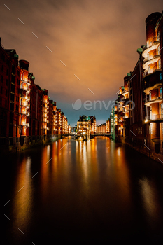 llumination light with reflection in the water. Located in Warehouse District – Speicherstadt Landmark of HafenCity quarter. Most visited touristic famous place