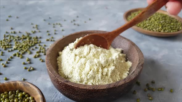 Mung beans flour with a wooden spoon close up