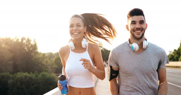 Attractive Man and Beautiful Woman Jogging Together