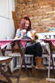 Happy young woman with Basset Hound smelling coffee at cafe table - PhotoDune Item for Sale