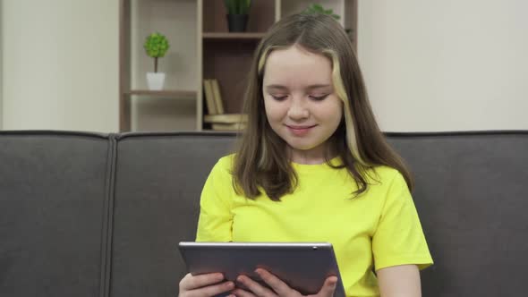 Lucky Girl Watching Videos on Her Tablet Computer