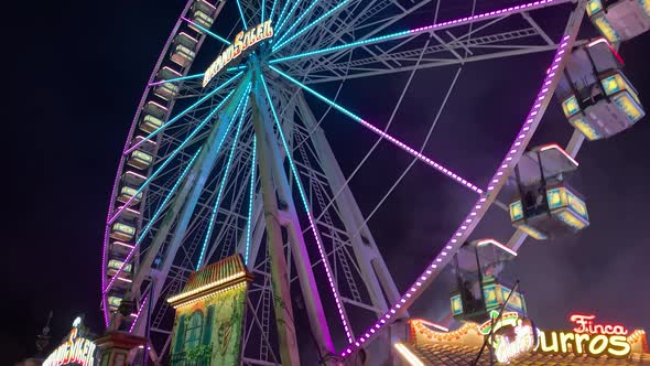 Tilt up Night Shot Of Big Lighted Ferris Wheel In Germany in funfair park