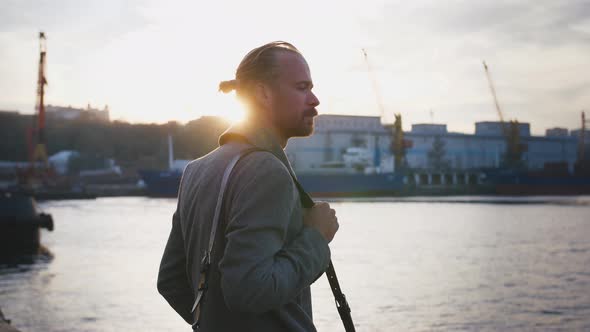 Portrait of Young Stylish Redhead Handsome Hipster Man on Sea Port Background During Sunset