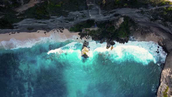 Top Down View on Hidden Sandy Beach with Azure Water