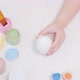 A Little Girl Painting an Egg with Easter Eggs on a White Background Top View - VideoHive Item for Sale