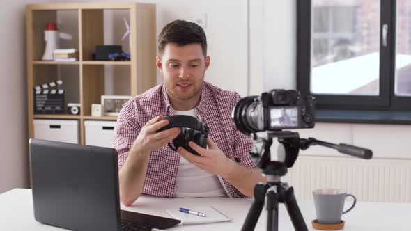 Male Blogger with Headphones Videoblogging at Home